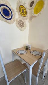 a table with two chairs and some decorations on the wall at Mina Luxe Machakos in Machakos