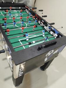 a foosball table with people playing a game at Sunset Groove Cafe in Nong Prue