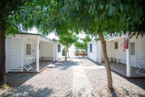 a row of white mobile homes with a tree at Aquarius Policoro in Policoro