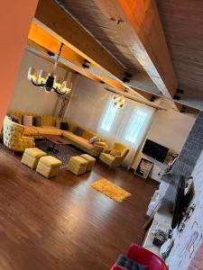 a living room with a couch and chairs in it at Bujtina Vjosa in Memaliaj