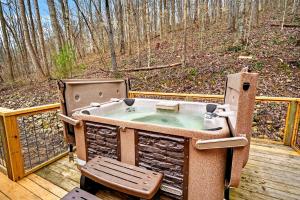 a hot tub sitting on a deck with a chair at Lane's End in Laurelville +43 photos