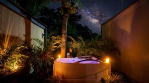 a night view of a hot tub with two candles at Tiny Love Room in Ao Nang Beach