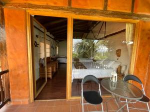 a room with a bed and a table on a balcony at Ilatoa Lodge in Quito