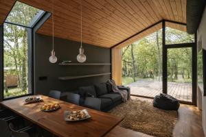 a living room with a couch and a table at Cabañas en Ribeira Sacra, Borbela de Luz in Villar de Ordelles