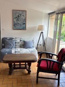 a living room with a bed and a chair at Carabas84 in Carpentras