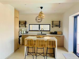 a kitchen with a table and some chairs in it at Vila Esnella - Private Pool & Panoramic Sea view in Primošten