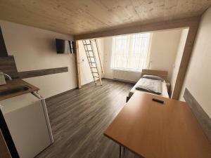 a small room with a bed and a desk in it at Drei Bären Hotel & Apartments in Aichach