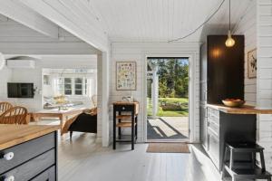 a kitchen and living room with a dining room and a table at TV1721-Jerup-Engsigen-12 in Bratten Strand