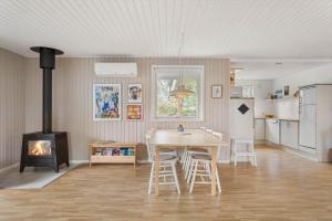 a living room with a table and a stove at TV1718-Bindslev-Astersvej-4 in Tversted +21 photos