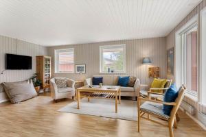 a living room with a couch and a table at TV1718-Bindslev-Astersvej-4 in Tversted