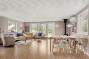 a living room with a table and a dining room at TV1718-Bindslev-Astersvej-4 in Tversted