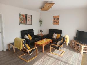 a living room with a couch and chairs and a table at Ferienhaus No.10 in Hemmoor