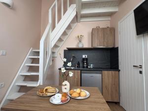 a kitchen with a table with plates of food on it at Aleminas Rooms 2 in Symi