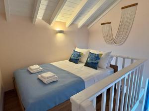 a bedroom with two beds with towels on them at Aleminas Rooms 2 in Symi
