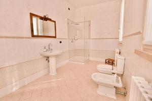 a white bathroom with a sink and a toilet at B&B Residence il Ciliegio , Via Villa Superiore 93 Luzzara in Luzzara +21 photos