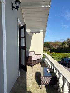 a porch with a chair and a table on a house at Sea Breeze B&B in Clonakilty +14 photos