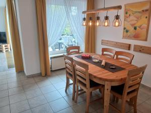 a dining room with a wooden table and chairs at Ferienhaus No.10 in Hemmoor