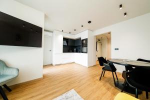 a living room with a dining room table and chairs at Еlite central stay apartment in Pleven