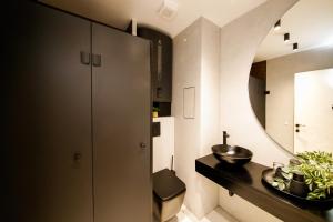 a bathroom with a sink and a mirror at Еlite central stay apartment in Pleven +4 photos
