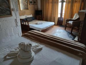 a bedroom with two beds with towels on the bed at Gozo Duplex Studio overlooking historic Piazza in Victoria