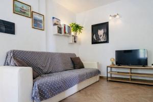 a living room with a couch and a tv at Lucia House in Santa Lucia