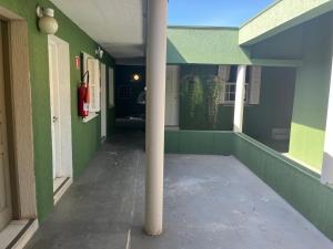 an empty hallway of a house with a pole at Hotel Casimiro in Ponta Grossa
