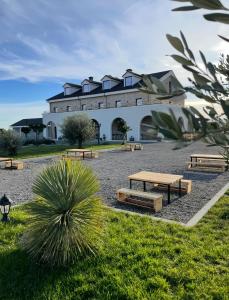 a building with picnic tables in front of it at Clean City Agrotourism in Durrës