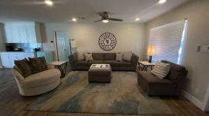 a living room with a couch and a table at Modern Arcadia Lite Oasis Pool Heater BBQ in Phoenix