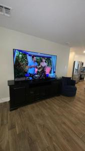 a large flat screen tv sitting in a living room at Modern Arcadia Lite Oasis Pool Heater BBQ in Phoenix