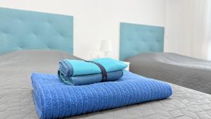 a pile of towels sitting on top of a bed at Caballero in Torrevieja