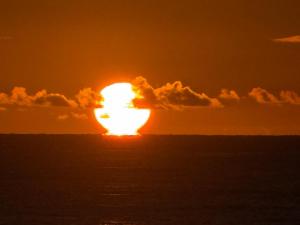 an image of the sun setting over the ocean at The Beach Loft by Xio in Humacao