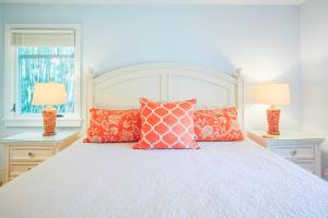 a bedroom with a bed with pillows and two lamps at Fiddlers Hideaway in Kiawah Island