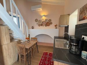 a kitchen and dining room with a table and a sink at Aleminas Rooms 2 in Symi
