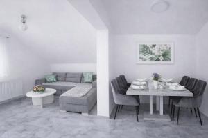 a living room with a table and a couch at Plitvice Harmony one - seven person in Smoljanac