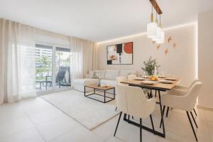 a dining room and living room with a table and chairs at Apartment Grape Panorama Mar Punta Prima in Punta Prima