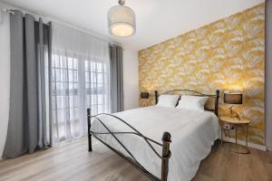 a bedroom with a bed and a yellow wall at Encanto dos Montes in Alvor +53 photos