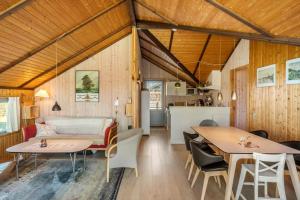a living room and kitchen with a couch and tables at M412-Stubbekobing-Birkehegnet-28 in Stubbekøbing