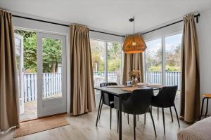 a dining room with a table and chairs at S745-Stroby-Garderhojen-35 in Strøby +13 photos