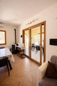 a living room with a sliding glass door with a table at Lucia House in Santa Lucia