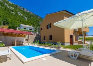 a villa with a swimming pool and a house at Villa Kapitulac in Grižane