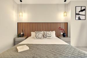 a bedroom with a large bed with a wooden headboard at Apartment Grape Panorama Mar Punta Prima in Punta Prima +55 photos