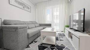 a living room with a couch and a flat screen tv at Caballero in Torrevieja