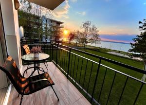 a balcony with a table and a view of the water at Siófok Panoráma Apartman in Siófok