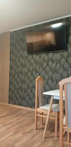 a dining room with a table and two chairs at Krakowski in Boguszów-Gorce