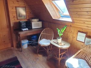 a room with a table and chairs in a cabin at Chalupa 58 in Štiavnické Bane