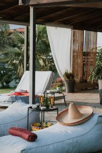 a hat sitting on top of two beds on a patio at Cuervo Poolside Villa in Kalívia Thorikoú