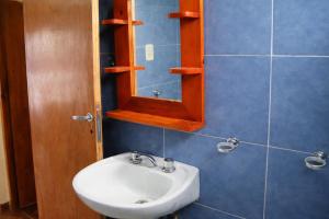 a bathroom with a sink and a mirror at Casa Jugo in Santiago del Estero