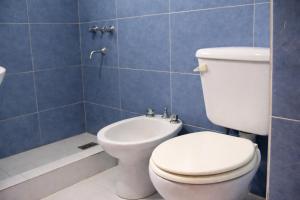 a bathroom with a toilet and a sink and a shower at Casa Jugo in Santiago del Estero