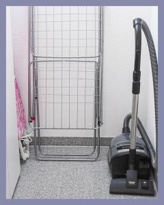 a vacuum cleaner on the floor in front of a gate at Schwarzwaldpension Tuttlingen in Tuttlingen +12 photos