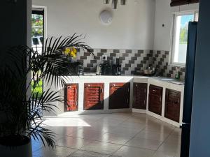 a kitchen with a sink and a counter top at Paradise Beach House in Vilanculos